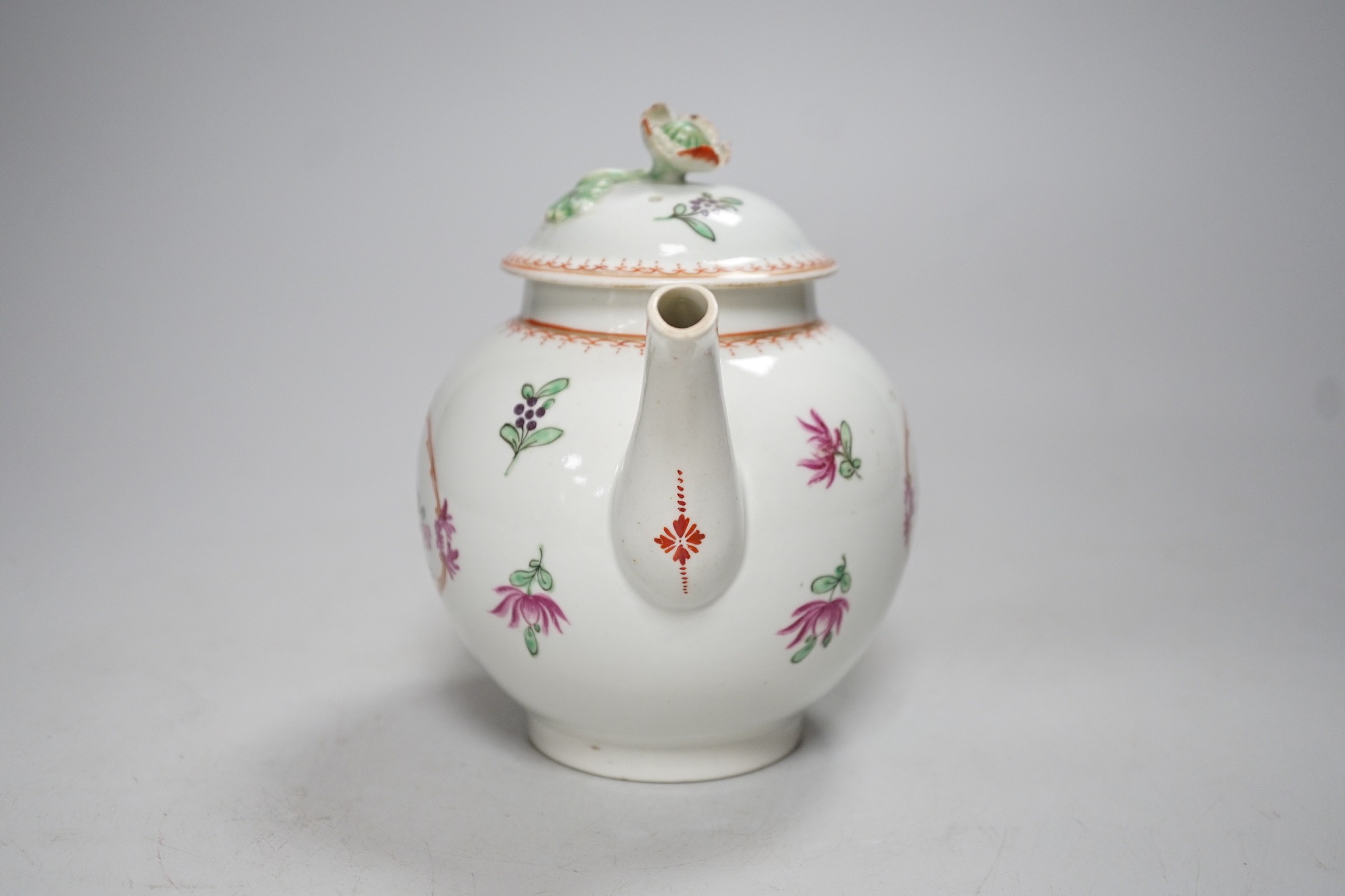 An 18th century Worcester teapot and cover painted in Chinese export style with flowers in an oval panel. 16cm tall